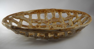 Hand-built pottery bread basket made on oval plaster mold, by weaving rolled out clay coils, in white stoneware. (Sample)