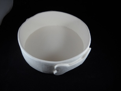 Stoneware dog bowl, made using slab draped on dog bowl mold. Dog bone handles added. Bisqued. (Sample)