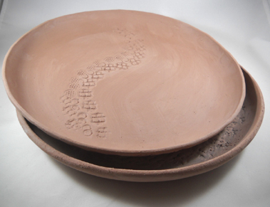 These sample hand-made plates made draping earthenware clays slabs on mold; Clay state: greenware.