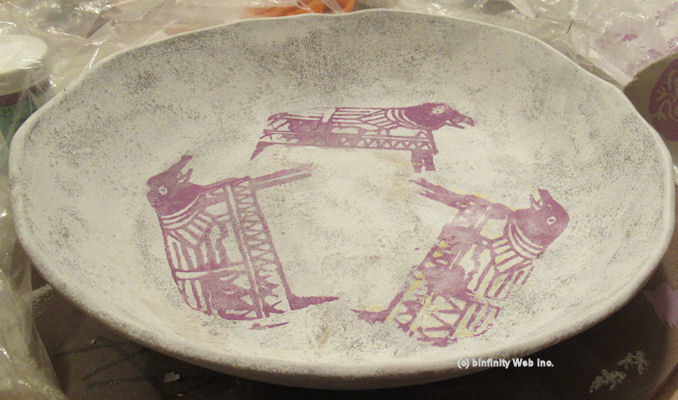 Hand-made deep wide plate sample in white stoneware with underglazes applied on greenware after removing from plaster mold; Clay state: greenware.