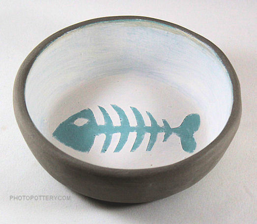 Hand-made pottery cat bowl made on plaster hump mold with stoneware clay and decorated using underglazes. Sample is in greenware.