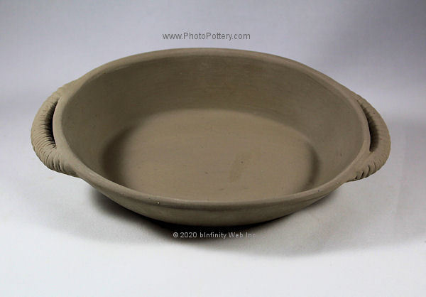 Sample serving dish made on oval plaster hump bowl mold. Decorative handles added after pottery removed from mold. Porcelain clay, greenware.